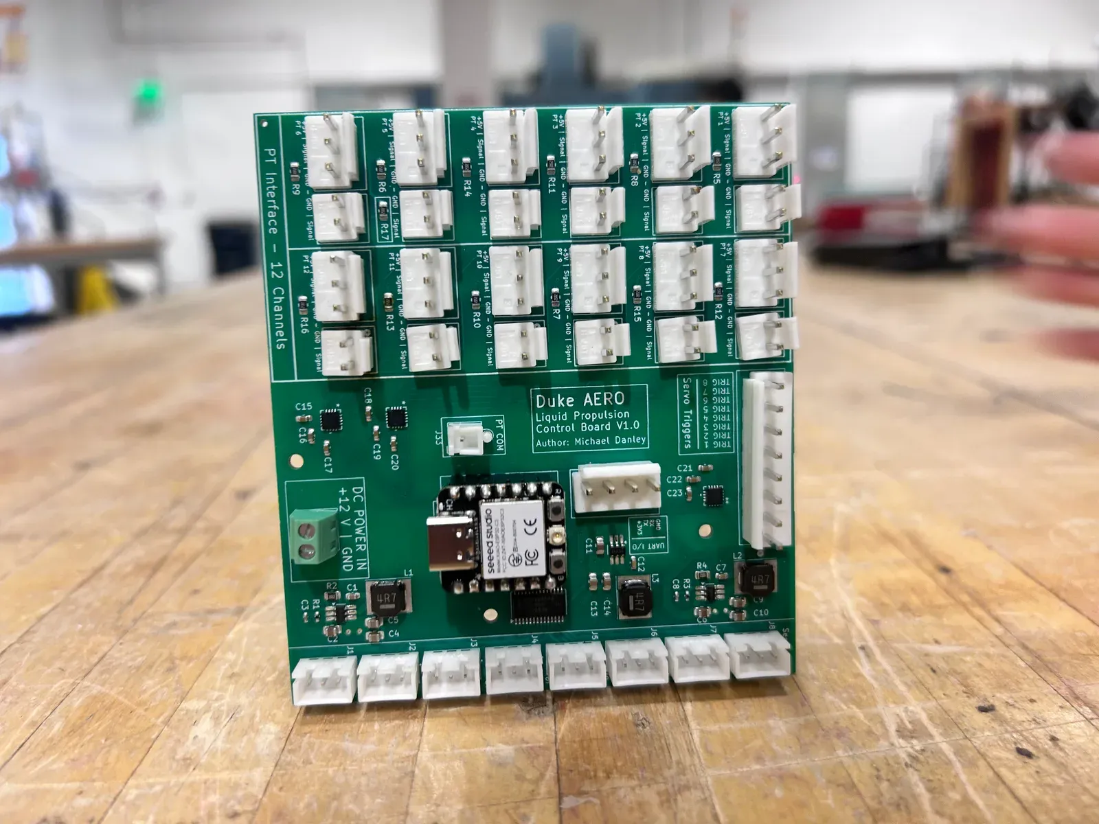 Duke AERO control board on a workbench, with rows of connectors along its edges.