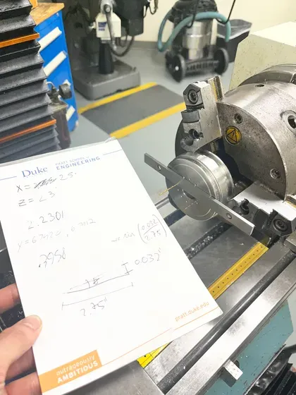 Lathe setup with handwritten calculations